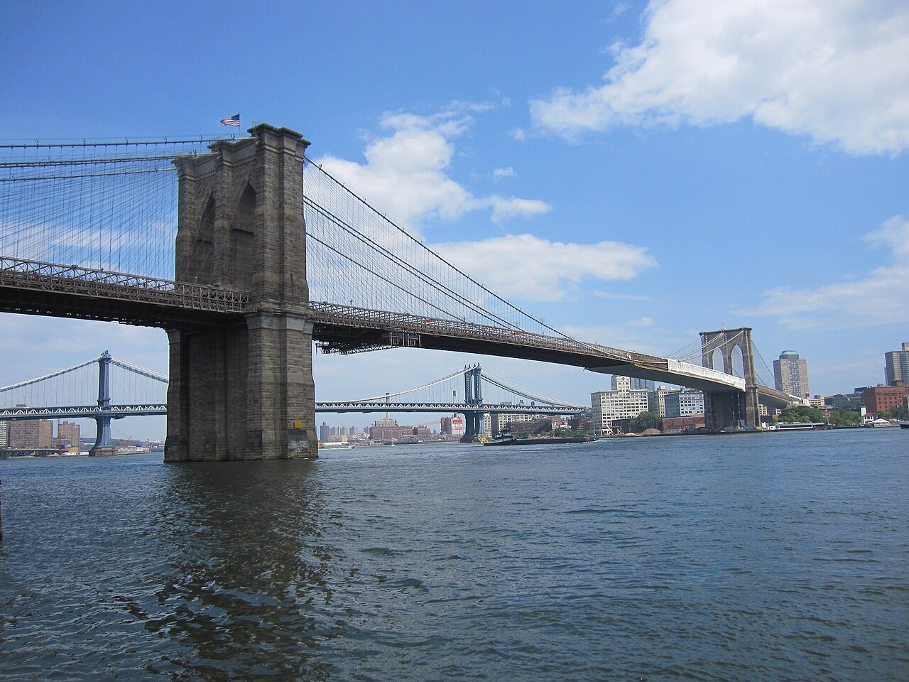 The Brooklyn Bridge from the water's edge, with the Manhattan Bridge in the distance