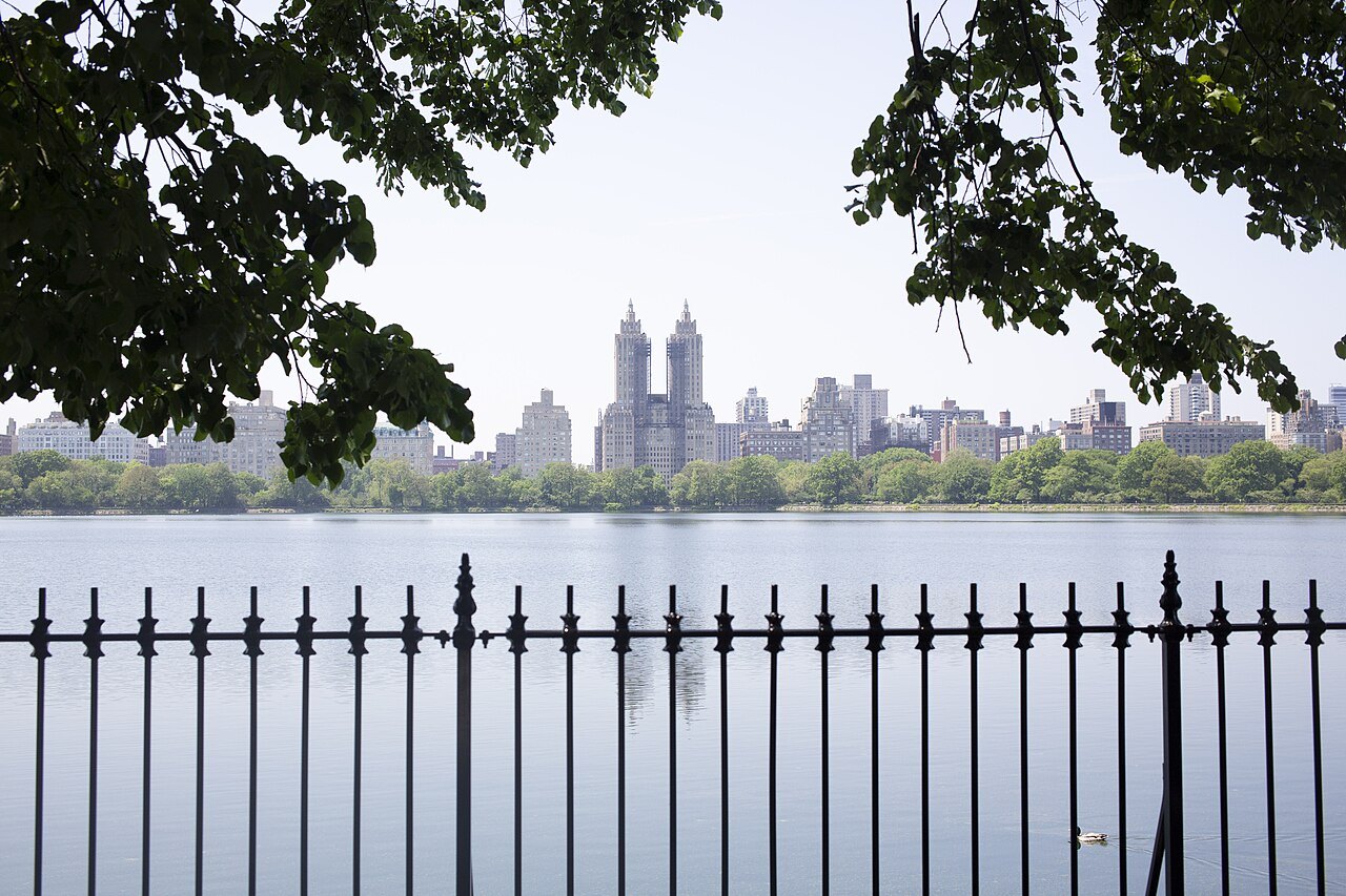 The twin towers of the San Remo across the Reservoir, seen through the park railings