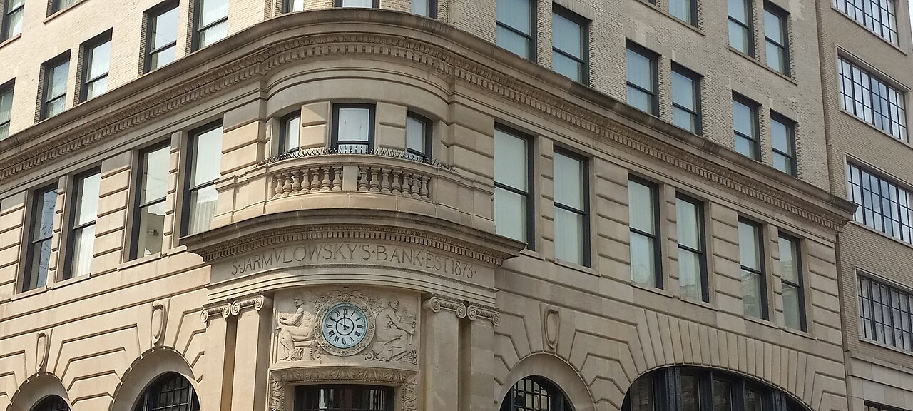 The clock and curved stone corner of the Jarmulowsky Bank Building on the Lower East Side