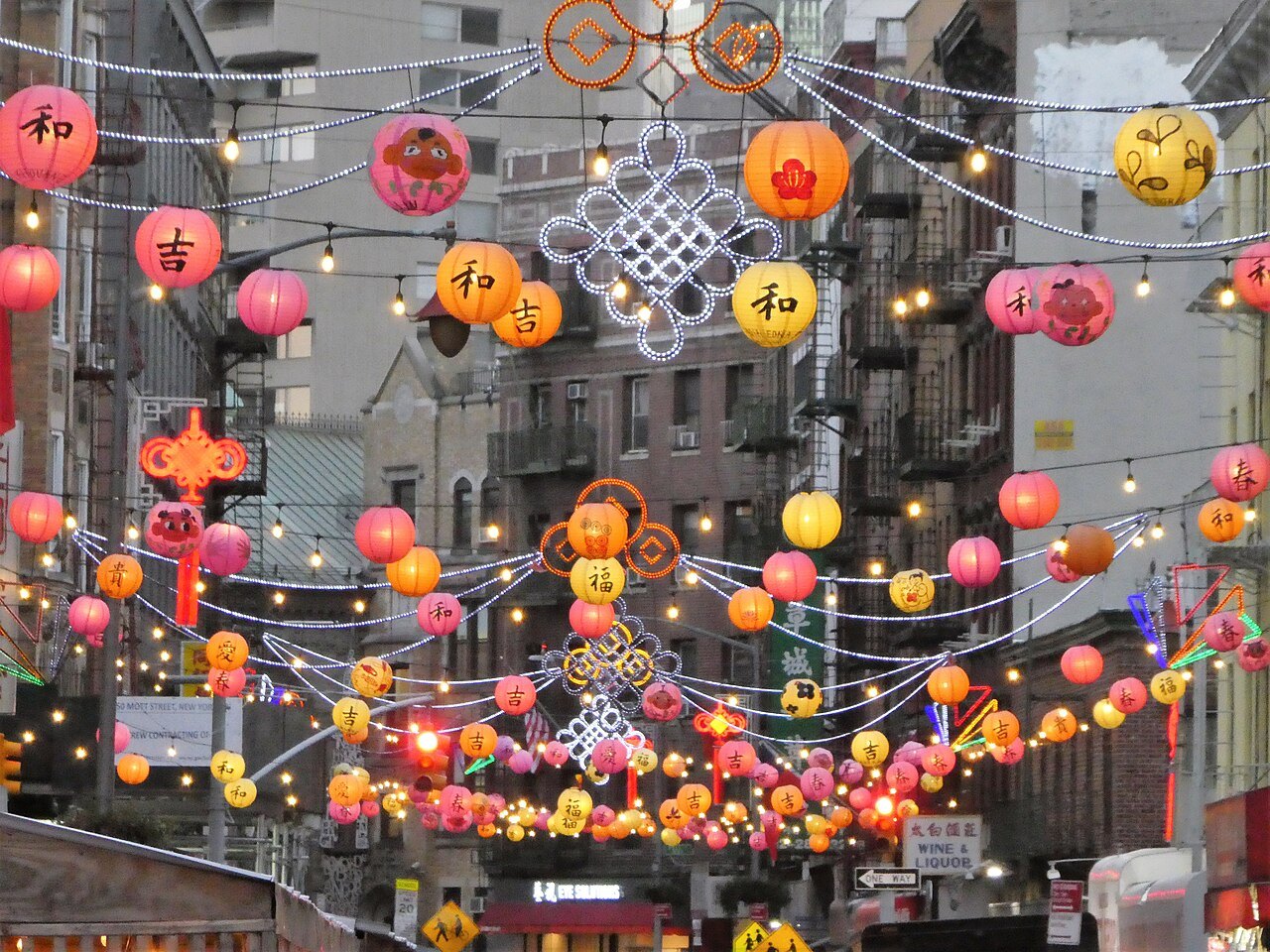 Red and gold lanterns hung across a Chinatown street