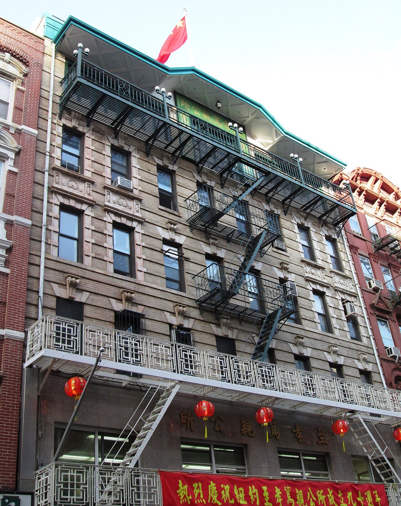 A tenement with fire escapes and red lanterns on Bayard Street