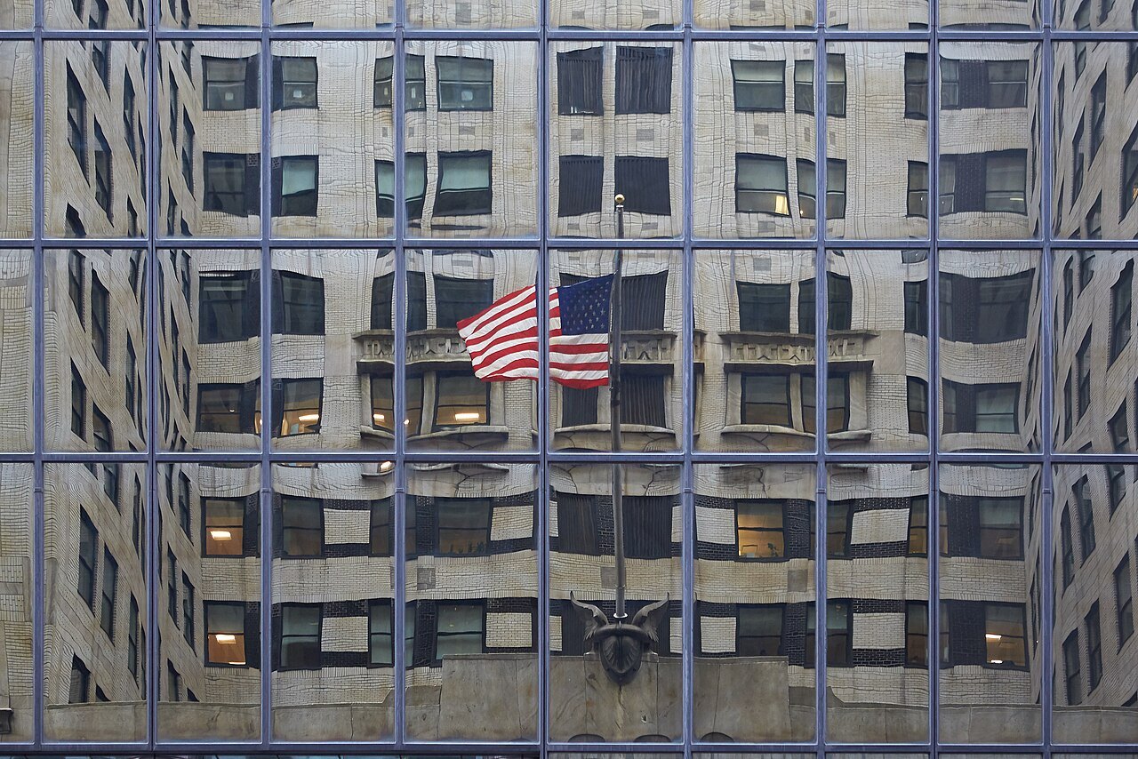 The Chrysler Building's facade reflected in a mirrored window grid