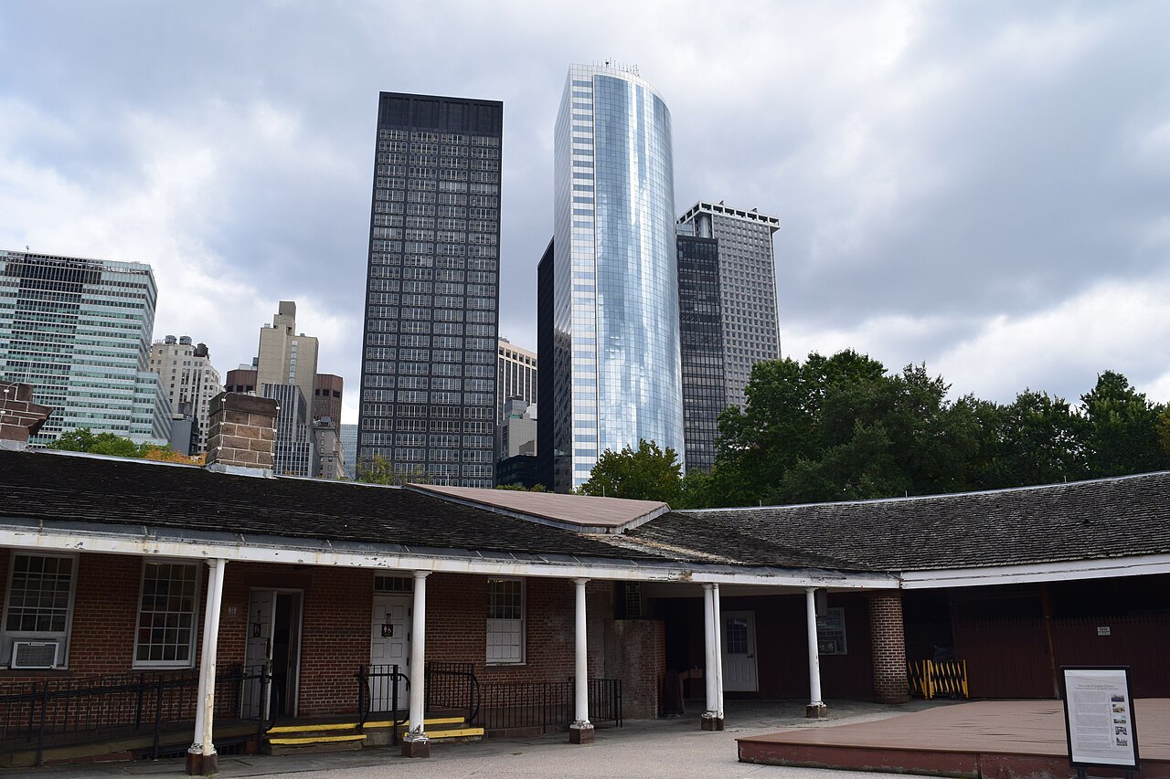 The low walls of Castle Clinton in Battery Park, with Lower Manhattan's towers behind