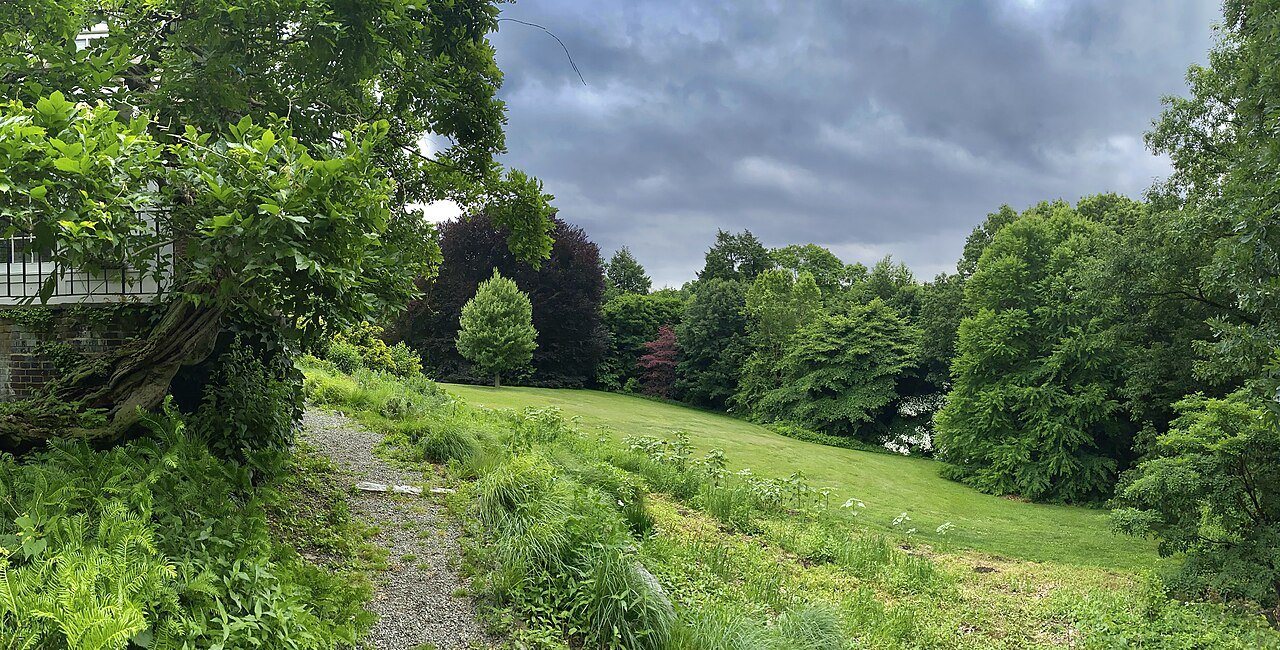 A grassy path under the trees at Wave Hill in the Bronx