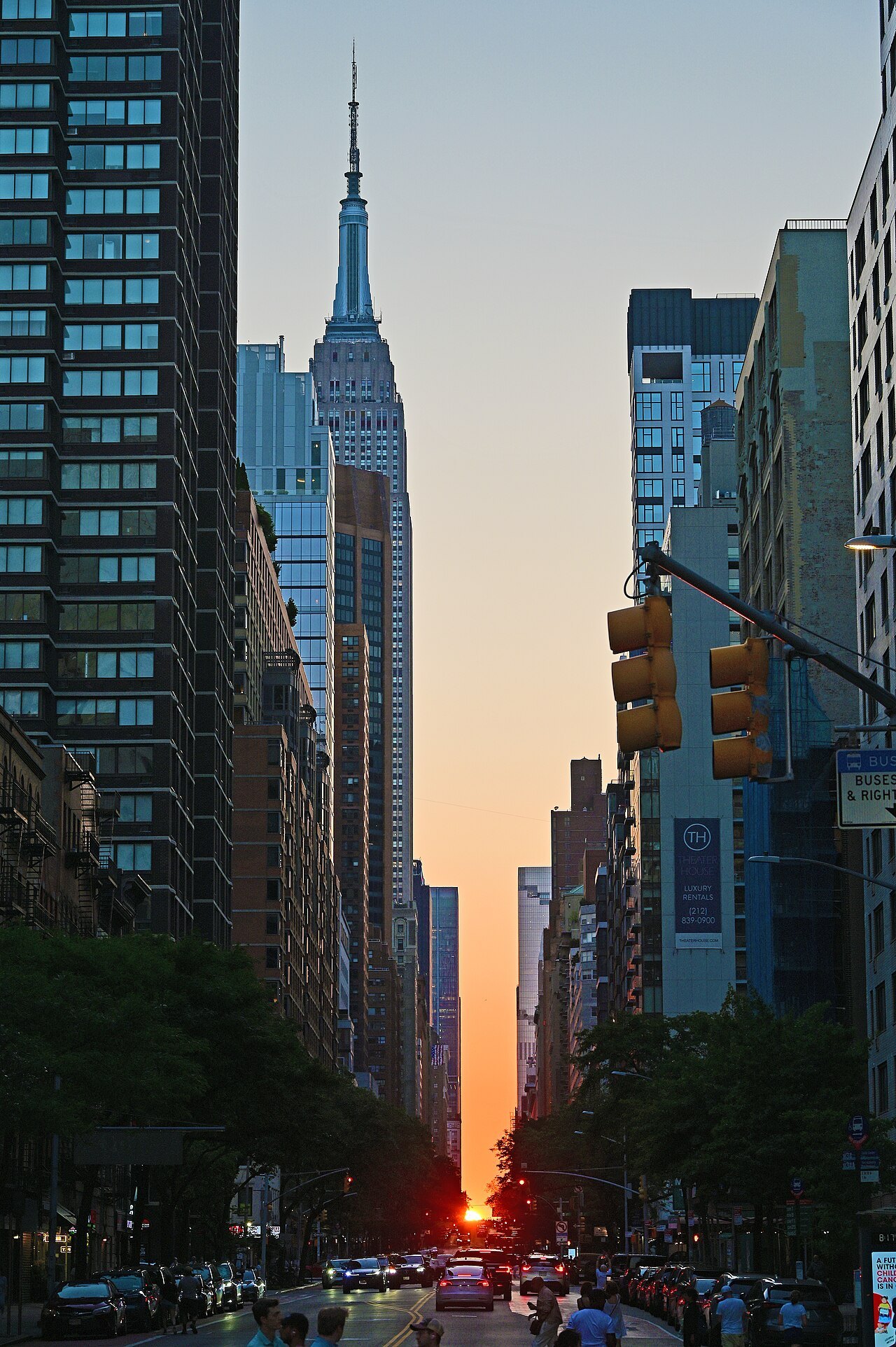 The sun setting at the end of a Midtown cross street, the Empire State Building to the left