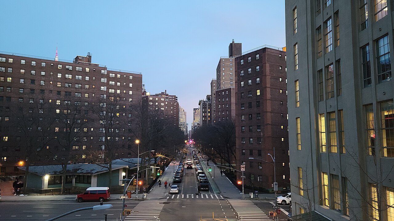 A cross street running away to the horizon at dusk, seen from the High Line