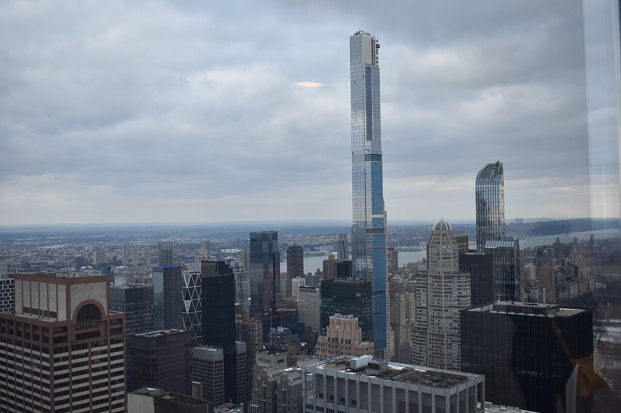The thin tower of Central Park Tower above Midtown on a gray day