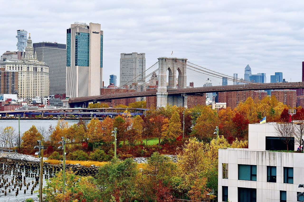 The Brooklyn Bridge above autumn trees in Brooklyn Bridge Park