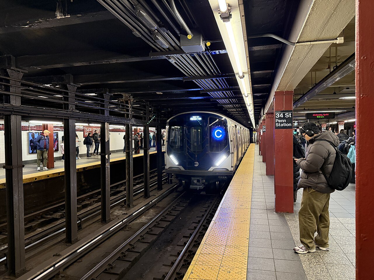An uptown C train pulling into the 34th Street station