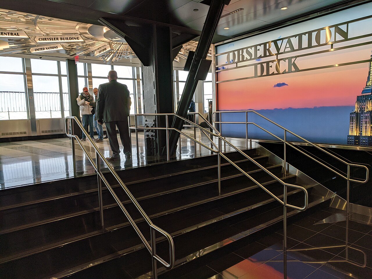 The indoor gallery of the 86th-floor observatory, with steps to the terrace