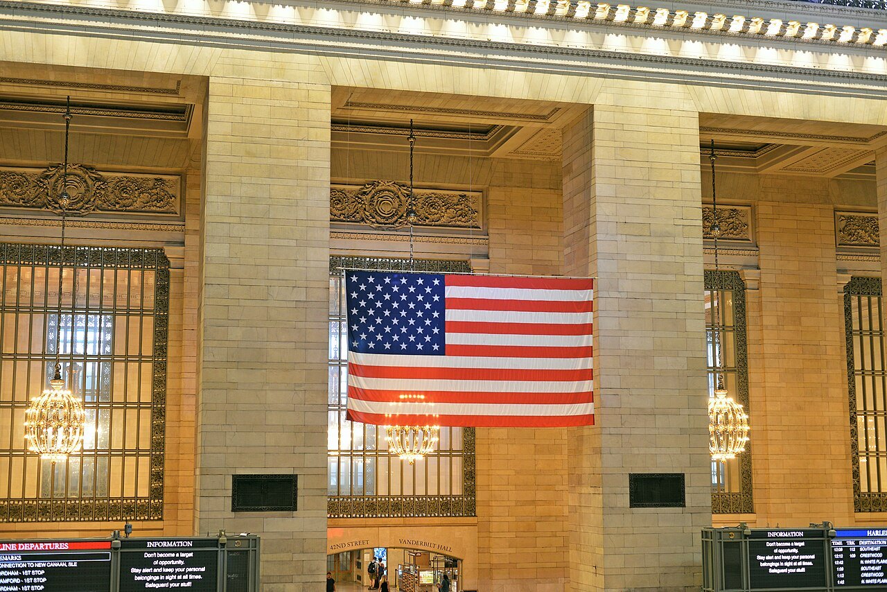 A great flag hanging between the windows of Grand Central's concourse