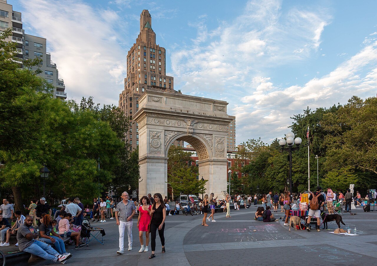 The Washington Square Arch on a summer evening, the plaza full of people