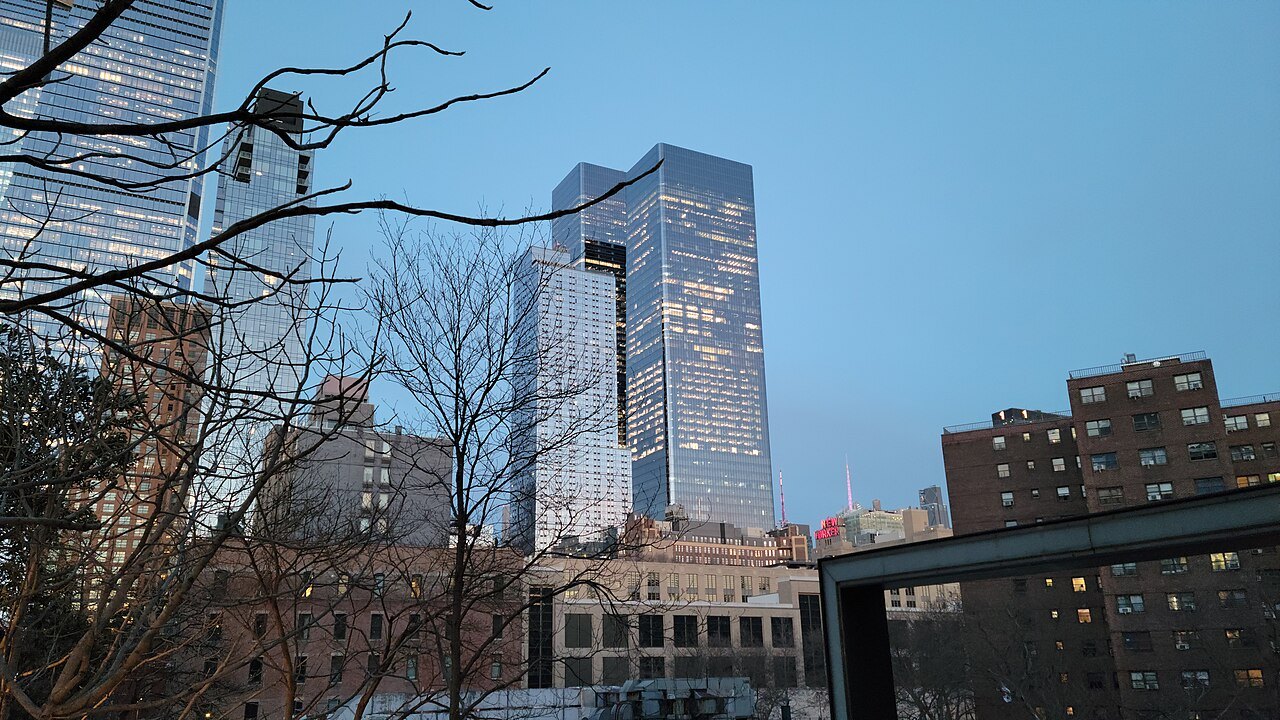 New towers seen through bare trees from the High Line's spur at 26th Street