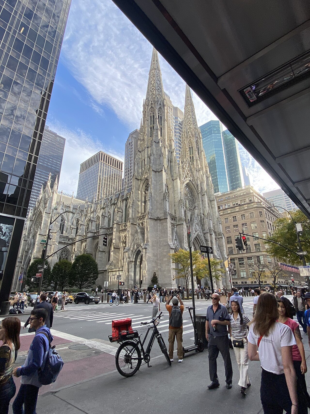 St. Patrick's Cathedral across a busy Fifth Avenue sidewalk
