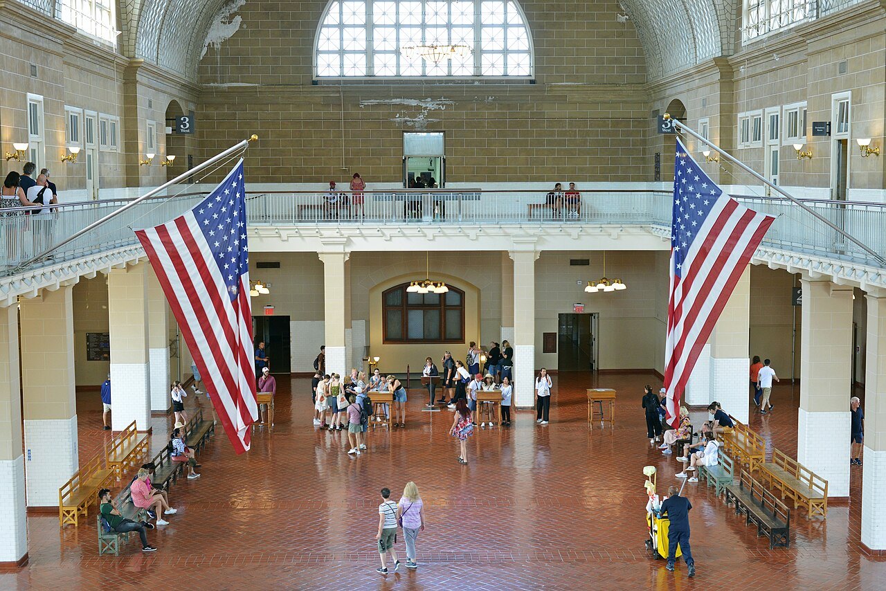 The Great Hall of Ellis Island's immigration museum, hung with flags
