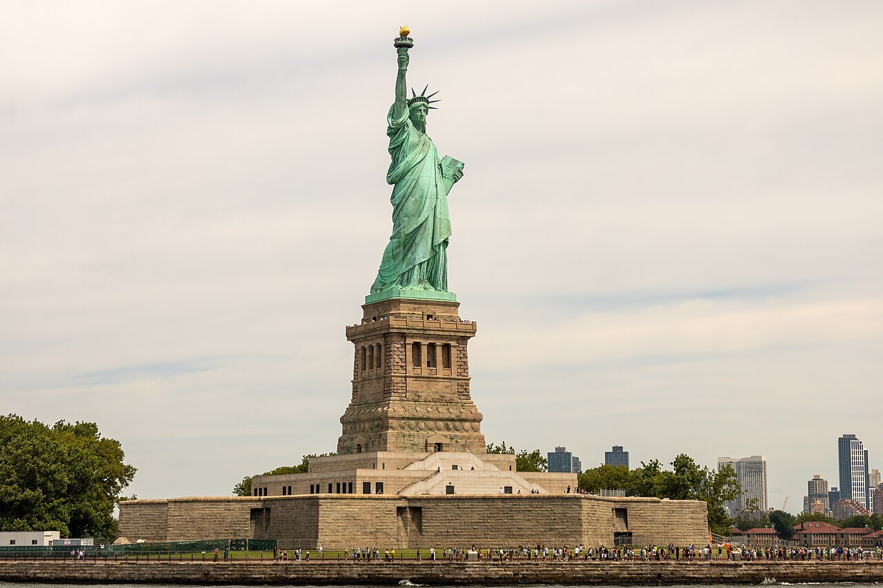 The Statue of Liberty and its star-shaped fort base from the harbor