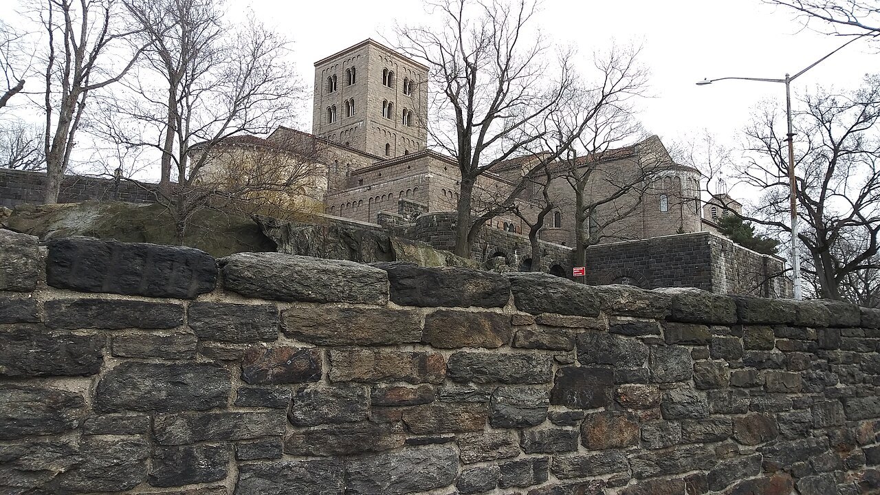 The Cloisters on its hill above a stone retaining wall