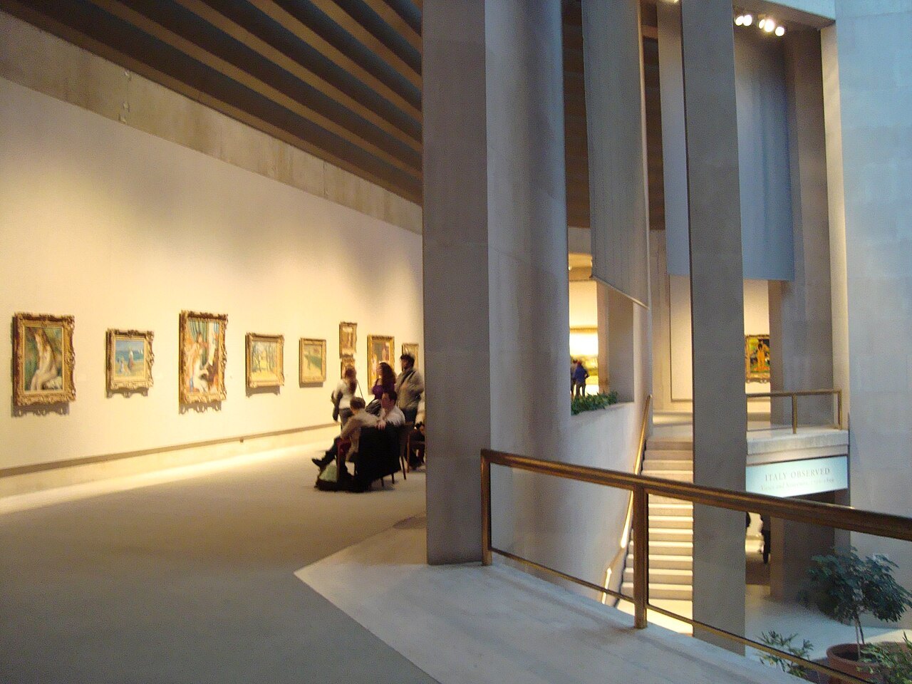 Visitors looking at paintings in the Robert Lehman Wing
