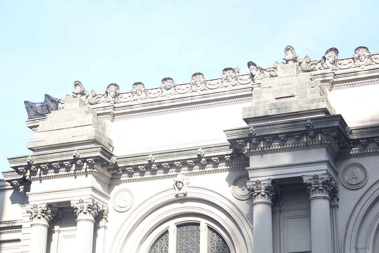 The carved cornice and arched windows of the Met's facade