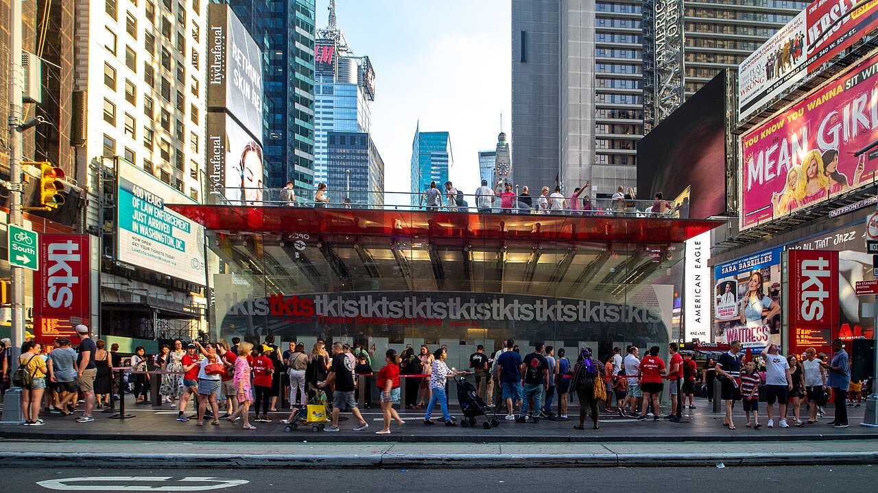 The TKTS booth under the red steps at Duffy Square, with a line in front