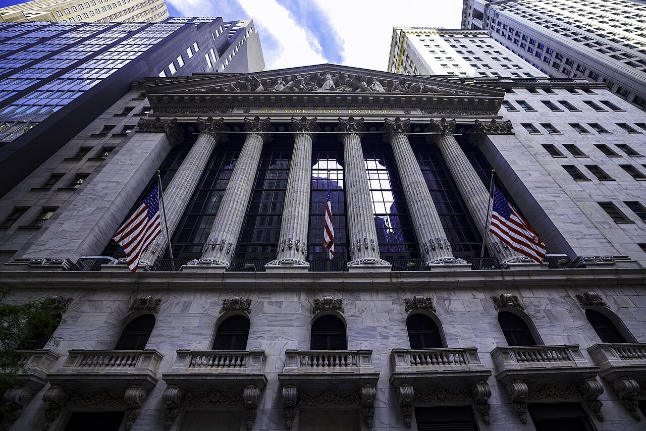 The New York Stock Exchange's columns from below, flags between them