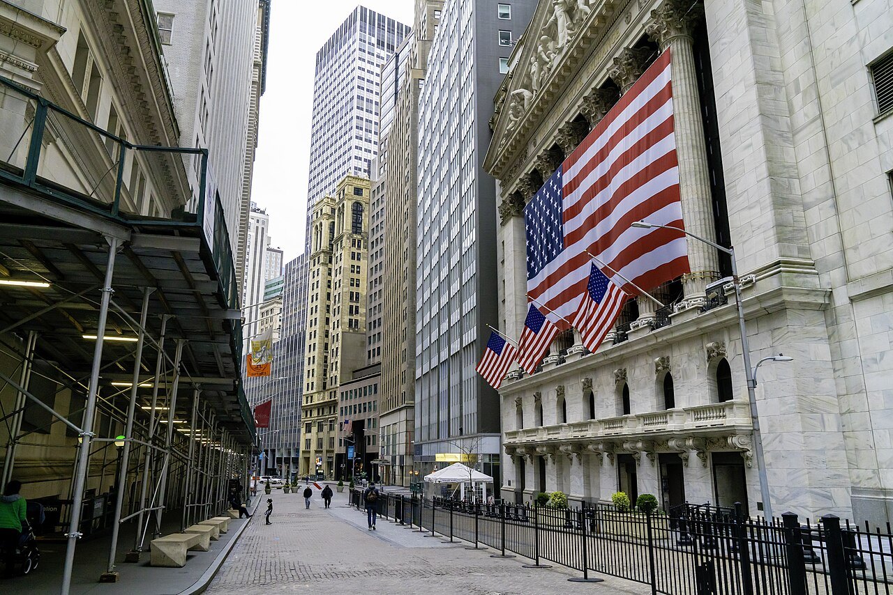 The flag-hung front of the New York Stock Exchange in the canyon of Broad Street