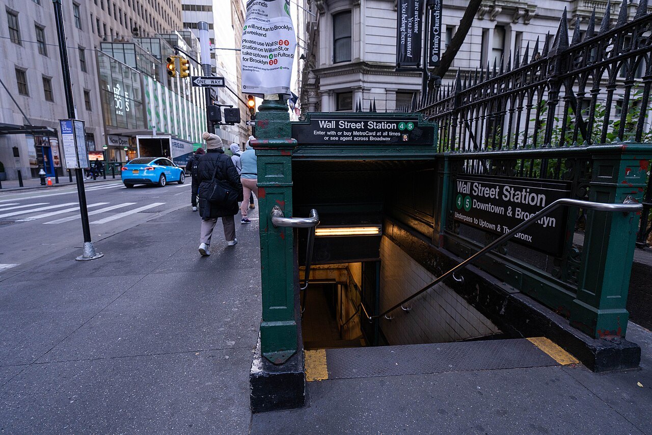 A subway entrance on Wall Street, with its iron railings