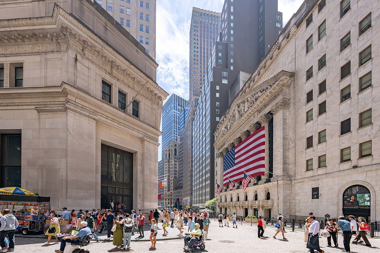 Crowds at the corner of Wall and Broad Streets, the Stock Exchange's flag above