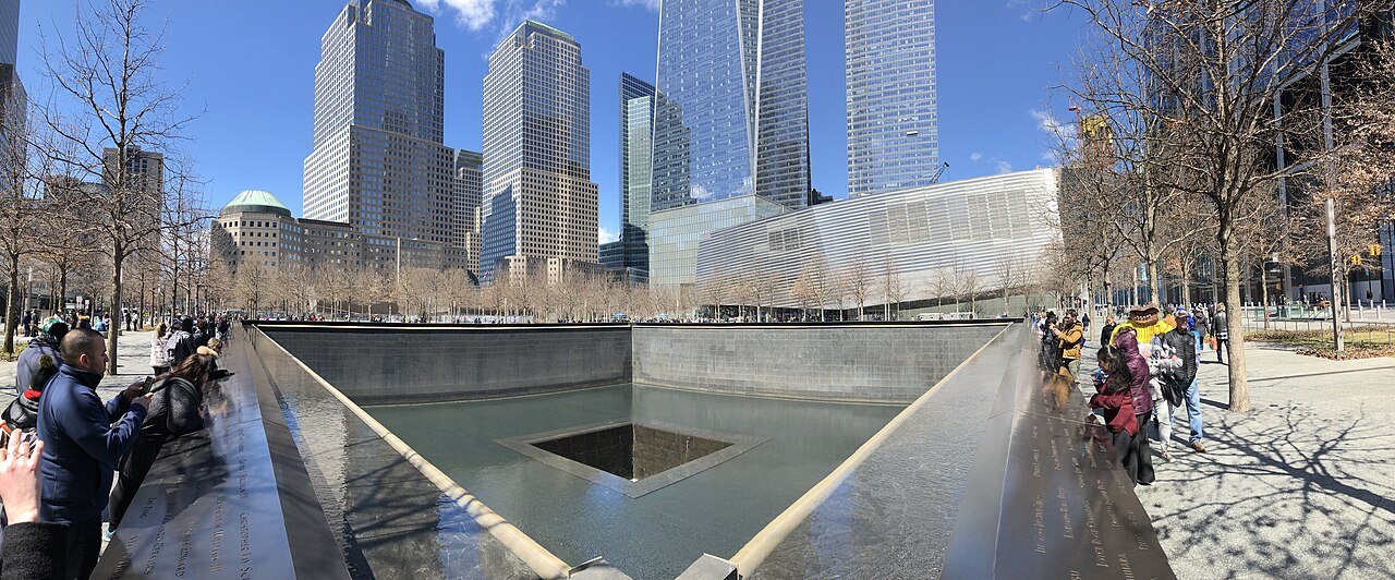 A memorial pool of the 9/11 Memorial, with the towers of the World Trade Center